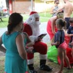 Santa Claus Giving Gifts — Caravan Park in Kinka Beach, QLD