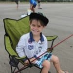 Kid With A Fishing Rod — Caravan Park in Kinka Beach, QLD